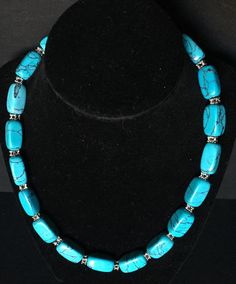 Believed to be the oldest gemstone known to man, Turquoise, has been mined for thousands of years. More recently, it's symbolic of the Native American's strong bond with Nature and Harmony. Even thousands of years later, Turquoise is still prized for its beautiful color and design. Today we offer one of the most prized Turquoise Gemstones known, Godber! Presenting this Beautiful Vintage Black Webbed Godber Turquoise Gemstone Necklace Featuring Silver Toned Spacer Beads With 17 Richly Appointed O Turquoise Polished Chrysocolla Beads Jewelry, Turquoise Chrysocolla Jewelry With Polished Beads, Turquoise Chrysocolla Polished Beads Jewelry, Blue Chrysocolla Necklace With Stones, Turquoise Polished Oval Beads Jewelry, Hand-strung Blue Turquoise Chrysocolla Necklace, Hand-strung Chrysocolla Turquoise Necklace, Chrysocolla Turquoise Necklace With Gemstone Beads, Blue Turquoise Necklace With Gemstone Beads