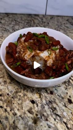 a white bowl filled with food on top of a counter