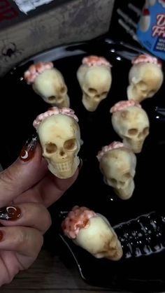 a person is holding some fake skulls in their hands