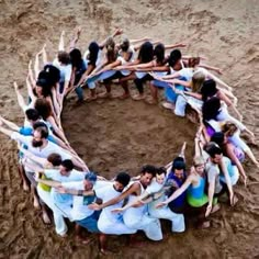 a group of people standing in the middle of a circle with sticks sticking out of it