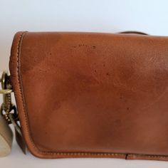 "Vtg Classic Original Coach Kisslock Dinky Leather with brass hardware Roomy interior with 1 slip pocket, attached kisslock coin pouch, outer slip pocket divided in two covered by a flap and secured with a turnlock Detachable 39\" strap Measures: 8\"L, 5\"H, 2\"W Made in New York, USA #348-4644 Flaws: 2 slots of leather in front, stains on front and stains on top and back Cleaned, conditioned and ready to wear! Questions? Just ask More vtg coach colors/styles also available Rc029" Classic Coach Leather Coin Purse, Retro Coach Shoulder Bag With Removable Pouch, Retro Coach Brown Bag, Vintage Coach Bag With Double Handle, Brown Coach Bag With Turn-lock Closure, Vintage Coach, Coin Pouch, Brass Hardware, Saddle Bags