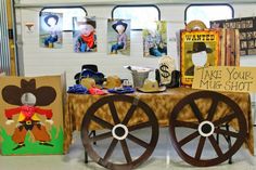 there is a table that has some pictures on it and two wooden wagon wheels sitting next to each other