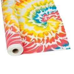 a multicolored tie - dyed yoga mat rolled up