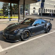 a black sports car parked in front of a building