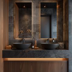 a bathroom with two sinks and mirrors in the wall above it is illuminated by lights