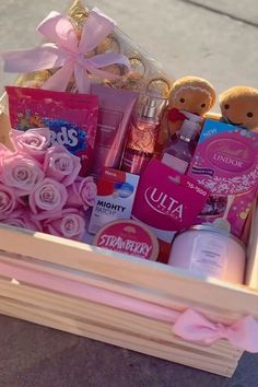 a wooden box filled with lots of pink items and teddy bears on top of it