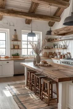 a kitchen with white cabinets and wooden counters