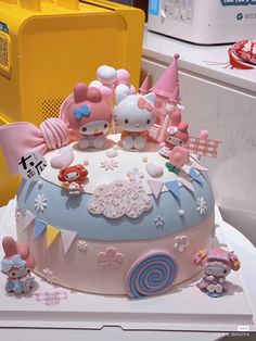 a hello kitty themed birthday cake on display