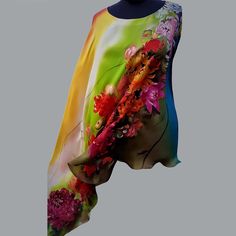 Hand painted silk tunic Dahlia, Аster flowers. Pure silk Hand-painted Tunic  Round neckline Loose fit Long sleeve Asymmetric sides Side slits Add this designer hand-painted silk tunic to your closet to have endless combination options. This silk tunic is made from natural silk. Intense vibrant colors from my Floral Collection . Feels light and flowy on the skin and easy to care for. Bright, saturated and abundant colors imply luxury combined with lightness, softness and grace. Each blouse is han Spring Asymmetrical Silk Blouse, Green Silk Blouse With Floral Print, Green Floral Silk Blouse, Spring Silk Tunic, Multicolor Silk Tunic For Spring, Spring Multicolor Silk Tunic, Elegant Multicolor Tunic For Summer, Elegant Multicolor Summer Tunic, Summer Silk Tunic With Floral Print