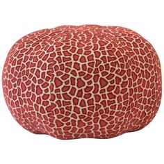 a red and white giraffe print poufce sitting on top of a white floor