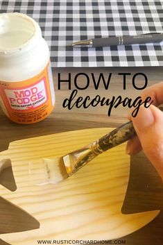 a person using a paintbrush to decorate a wooden sign with the words how to decopage on it