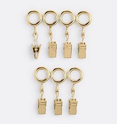 six pairs of gold tone metal keychains with clip closures on each side