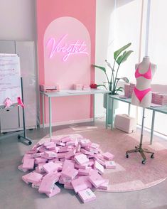 a room filled with lots of pink boxes in front of a sign that says vegetati