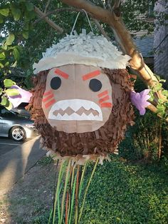 a paper mache is hanging from a tree