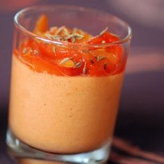 a small glass filled with food on top of a table