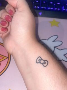 a person's arm with a tattoo on it and a mouse in the background