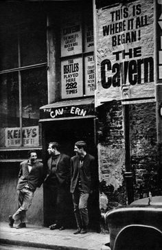 three men are walking down the sidewalk in front of a store that sells honey syrup