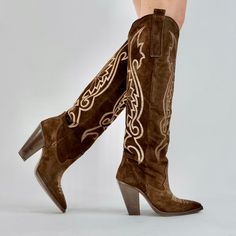 Introducing "Molly" - a stunning knee-high black leather western boot. With its bold and edgy design, Molly captures the essence of Western style with a contemporary twist. Crafted from chocolate brown kid suede, these knee-high boots exude confidence and sophistication. The intricate western-inspired details, like the pointed toe and stacked heel, add a touch of rugged charm. Whether you're heading to a music festival or stepping out in the city, Molly is the perfect companion for making a bold Taylor Rousseau, Brown Kid, Womens Fall Boots, Edgy Design, Fall Boots, Modern Western, Handmade Boot, Exude Confidence, Leather Western Boots