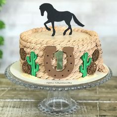 a birthday cake with a horse on top and the number 10 is made out of wicker