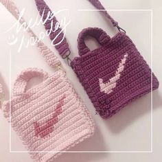 two crocheted purses sitting next to each other