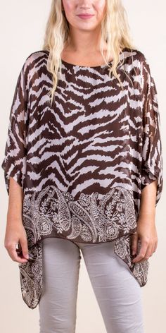 100% Silk Kaftan Style Blouse with Unique Multi-Print Design. Features 3/4 Length Sleeves and a Wavy Bottom. Exterior: 100% Silk Interior: 95% Viscose, 5% Elastic Fits Sizes XS- XL Made in Italy Beach Blouse With Half Sleeves And Print, Printed Half Sleeve Beach Blouse, Beach Half Sleeve Printed Blouse, Brown Short Sleeve Beach Blouse, Beach Printed Brown Blouse, Beach Blouse With Brown Print, Elegant Brown Beach Top, Elegant Brown Beach Tops, Elegant Beach Tops With 3/4 Sleeves