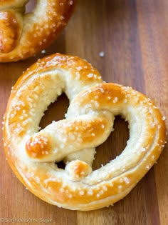 two soft pretzels on a wooden surface