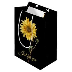 a black bag with a yellow sunflower on the front and writing that says, just for you