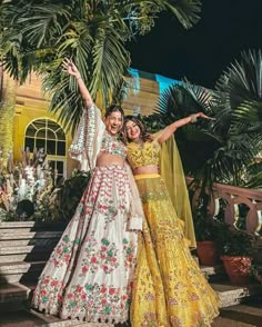 two women standing next to each other in dresses