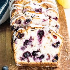 a loaf of blueberry bread on a cutting board