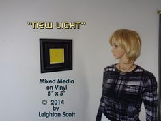 a mannequin is standing in front of a new light advertisement