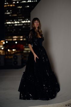 Our classic Ritz gown is upping the ante in Onyx Sequins, just in time for New Year's Eve. This dreamy princess statement piece, with its high waist, underwire bust, and corset-style top, has the perfect amount of give to look and feel great while toasting to a new beginning. Onyx Sequins is deep and rich, like the midnight sky, its dark black expanse enhanced by the captivating sparkle of sequins. Sequined gown with full cups and underwire Maxi length Pleated ruffle hem Selkie signature puff sl Black Puffy Sleeve Gown, Black Selkie Puff Dress, Selkie Ritz Gown, Luxury Black Long Sleeve Sequin Dress, Luxury Black Sequined Maxi Dress, Sparkly Bridesmaid Dress, Silk Dressing Gown, Corset Skirt, Corset Style Tops