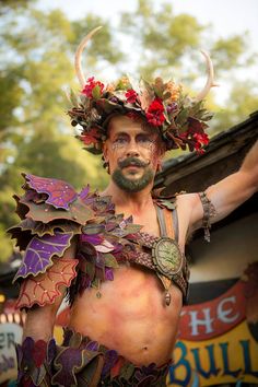 a man dressed in costume with horns and flowers on his head