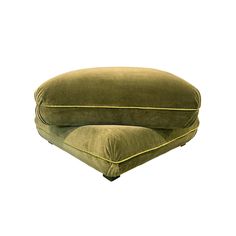 a large green cushion sitting on top of a pillow