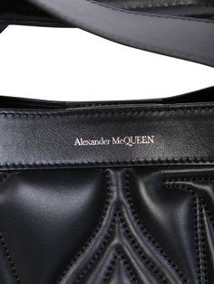 This Alexander McQueen bag boasts a structured silhouette defined by sharp linesQuilted. Embroidered logo on the front. Magnetic fastening. Main compartment. Adjustable detachable shoulder strap. Flat top handles. Color: blackWidth: 43 cm Height: 30 cm Depth: 14 cm Strap: 50 cmMaterial: 100% Calf LeatherMade in ItalyGender: WOMENMaterial: 100% CALF LEATHERColor: BLACKMade in: ITProduct ID: 709566 1BLFU 1000*Import tax/duty will be calculated at checkout (If applicable) Formal Tote Shoulder Bag With Logo Hardware, Black Leather Satchel With Logo, Leather Satchel With Logo And Top Handle, Leather Top Handle Satchel With Logo, Black Top Handle Satchel With Logo, Designer Logo Satchel Bag, Formal Double Handle Bag With Logo, Designer Satchel With Logo Hardware And Double Handle, Designer Satchel With Double Handle And Logo Hardware