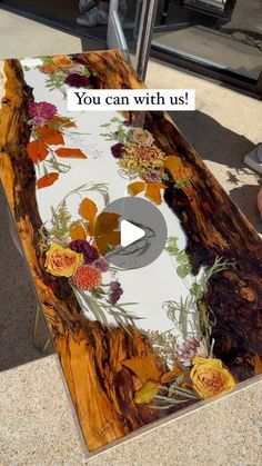 a wooden table with flowers painted on it and the words you can with us written in white