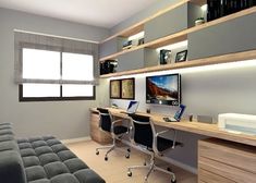 an office with two desks and a couch