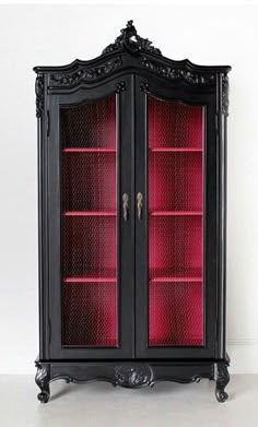 an ornate black cabinet with red glass doors