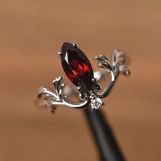 It is a garnet ring. The main stone is 5 mm* 10 mm marquise cut. weight about 1.35 carats. The basic metal is sterling silver and plated with rhodium. To change the metal to a solid gold (white/rose) or platinum is also available, please ask for a quotation if you want. You can also go to my shop Home for more elegant rings: https://www.etsy.com/shop/godjewelry?ref=hdr_shop_menu Alexandrite is June birthstone More alexandrite rings: https://www.etsy.com/shop/godjewelry?ref=seller-platform-mcnav& Silver Marquise Cut Ruby Jewelry, Silver Ruby Jewelry With Marquise Cut, Silver Marquise Cut Ruby Promise Ring, Garnet Engagement Ring Silver, Ruby Engagement Ring Silver, Ruby Ring Silver, Alexandrite Rings, Nontraditional Engagement Rings, Gothic Wedding Rings