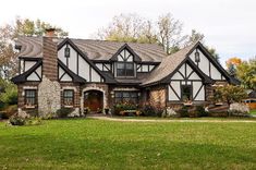 a large house with lots of windows in the front yard