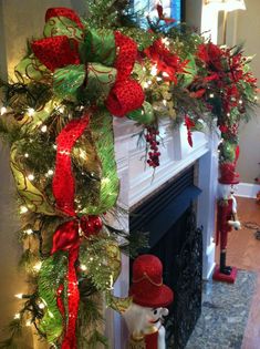 a christmas tree decorated with red, green and gold ribbon hanging from it's branches