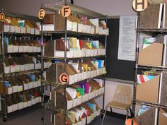 the shelves are filled with many different types of file folders and binder boxes