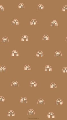 a brown background with white rainbows on it