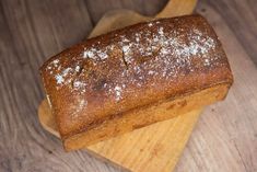 a loaf of bread sitting on top of a wooden cutting board