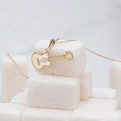 Strum the strings of elegance with our 14K Gold Classic Guitar Necklace, a perfect harmony of style and craftsmanship. This handmade piece is designed for music lovers, featuring a dainty yet detailed guitar charm that captures the essence of a musician's soul. Whether you're a guitar player or simply a fan of the art, this tiny music charm necklace is a timeless accessory that resonates with passion. ⚜️ Package included: One Handmade Necklace ⚜️ Pendant Sizes: 14 / 16 / 18 / 20 / 22 / 24 / 26 / Guitar Necklace, Guitar Jewelry, Spiritual Necklace, Handmade Guitar, Classic Guitar, 14k Gold Necklace, Timeless Accessories, Necklace Dainty, Guitar Player