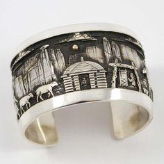 Wide Sterling Silver Cuff Bracelet with an Intricate Navajo Storyteller Design Depicting the Traditional Navajo Life including a Hogan, Sheep, a Horse, a Navajo Weaver at the Loom, and a Background of the Walls of Canyon de Chelly, Clouds, and a 14k Gold Sun in the Sky. 1.5” Cuff Width5.25” Inside Measurement, plus 1” opening(6.25" Total Circumference - Small-Medium) Navajo Weaver, Sun In The Sky, Canyon De Chelly, Zuni Jewelry, Concho Belt, Navajo Jewelry, Gold Sun, Native Jewelry, Stone Inlay