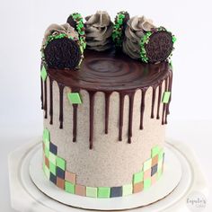 a cake decorated with oreo cookies and chocolate icing on a white platter