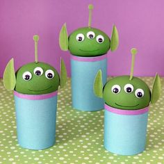 four little green alien cups with sticks sticking out of them