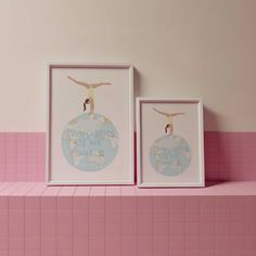 two framed art pieces on a pink shelf