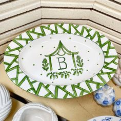 a green and white plate with the letter b on it