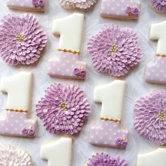 purple and white decorated cookies arranged in the shape of numbers one, two, three